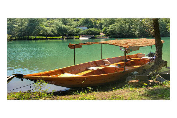 Traditional wooden boat offering cruising Virpazar-Montenegro